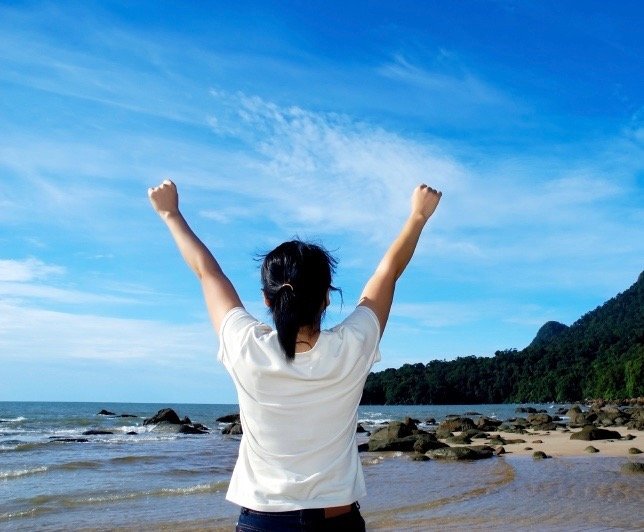 Woman victorious with work-life balance tablet